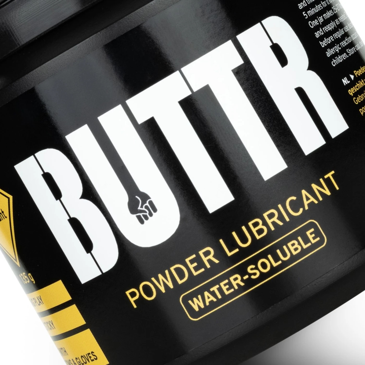 Extreme close-up shot of the black jar label highlighting the bold white "BUTTR" logo featuring a fist icon inside the letter U.