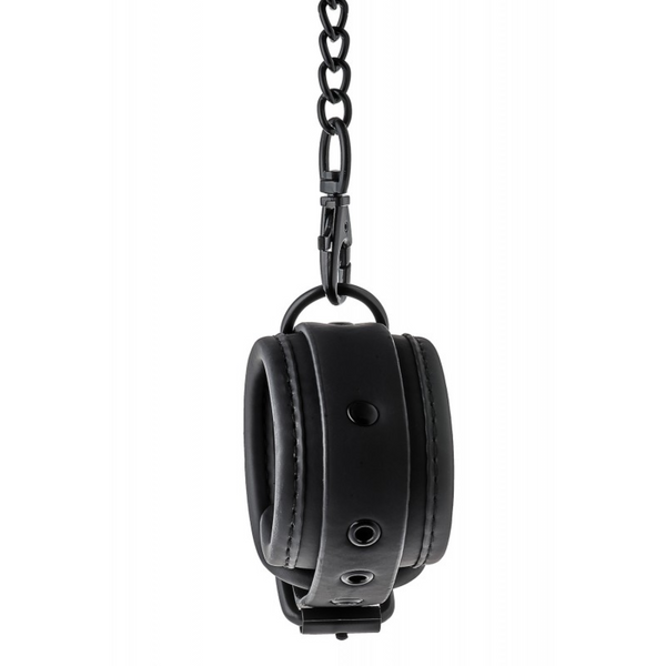 A single black, Blaze Luxury Fetish Hand Cuff hanging from a chain and clasp, viewed from the side.