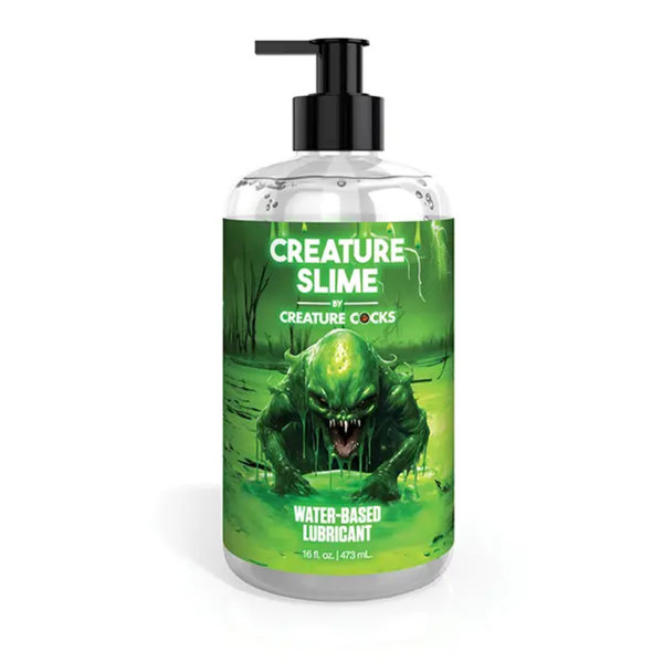 Front studio view of the 16 fl oz (473 ml) clear pump bottle of Creature Cocks Creature Slime Water-Based Lubricant, featuring swamp monster artwork on a green label.