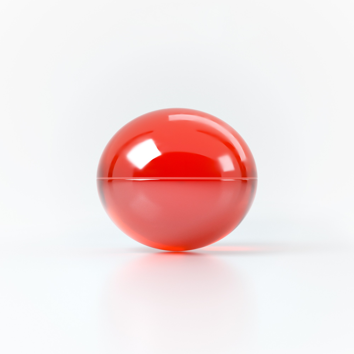 Studio product shot focusing on a single translucent red oil sphere resting on a clean white reflective surface.