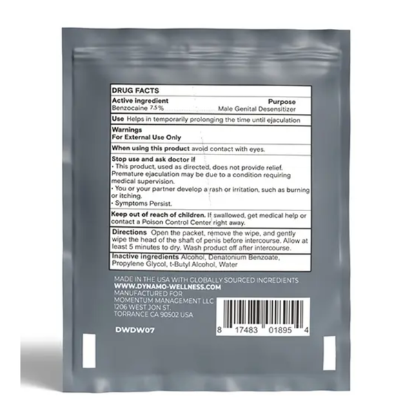 Direct view of the back Drug Facts panel on an individual Dynamo Wellness Delay Wipe packet, detailing active ingredients, purpose, directions, warnings, barcode, and manufacturer info.
