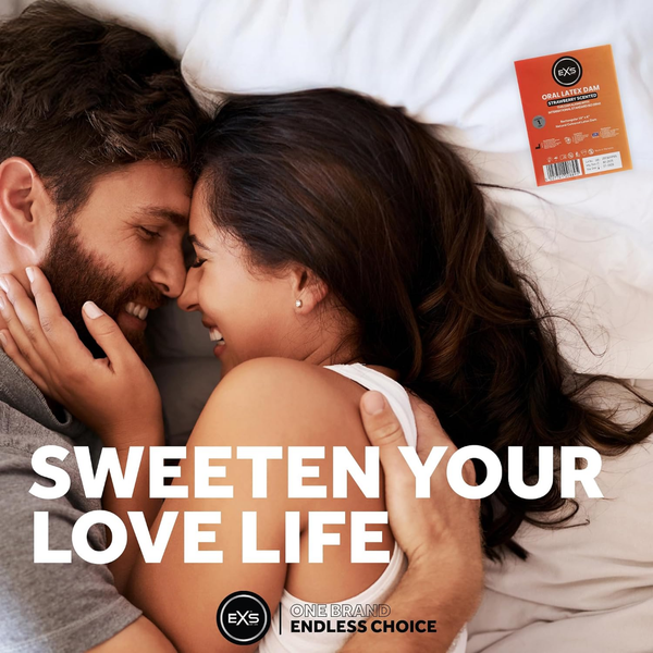Lifestyle image of a smiling couple embracing closely in bed. Bold text overlay reads "SWEETEN YOUR LOVE LIFE," accompanied by a single-pack EXS Strawberry Scented Oral Latex Dam in the upper right corner.