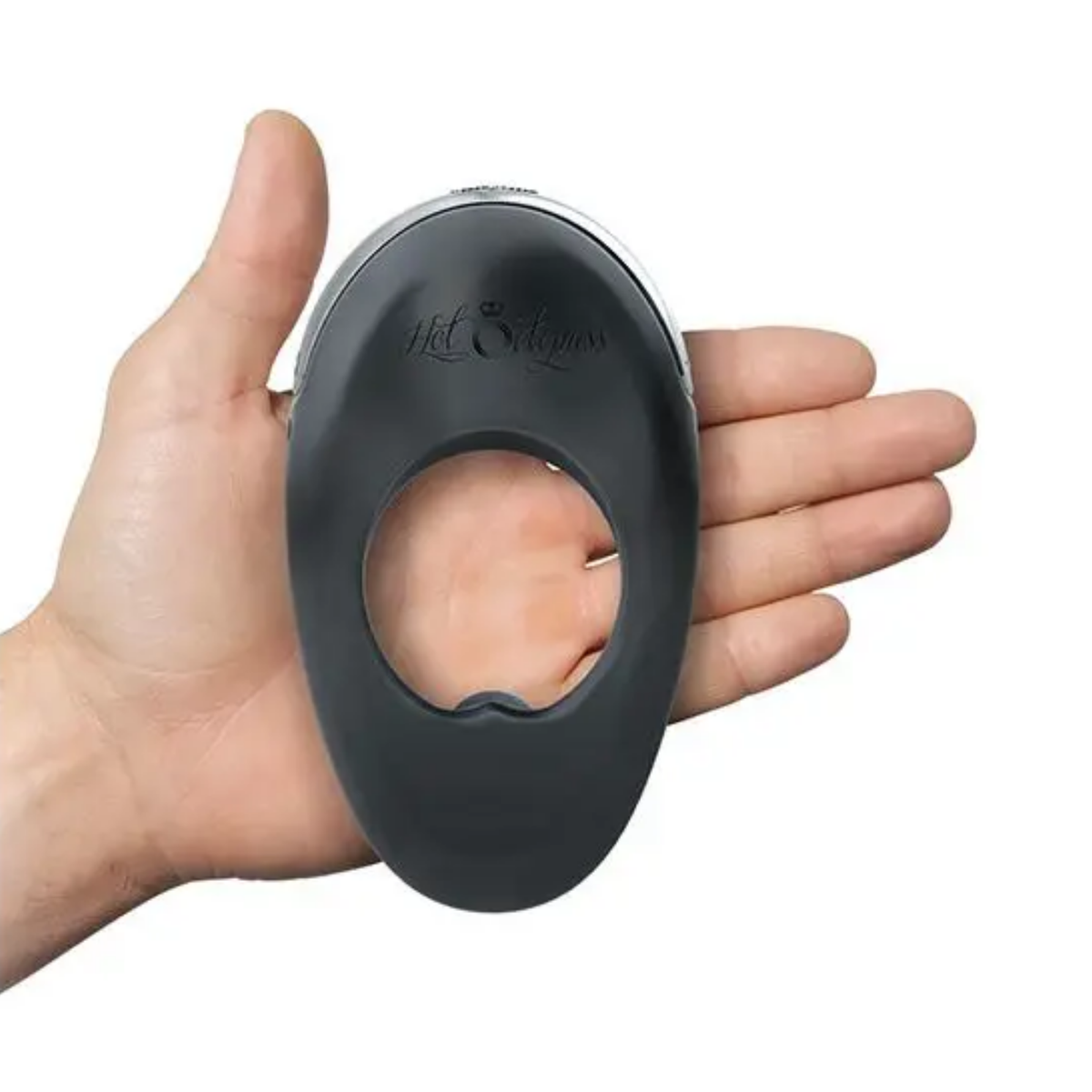 Scale perspective photo showing an open hand holding the ergonomic black silicone Hot Octopuss Atom Plus vibrating c-ring across the palm.