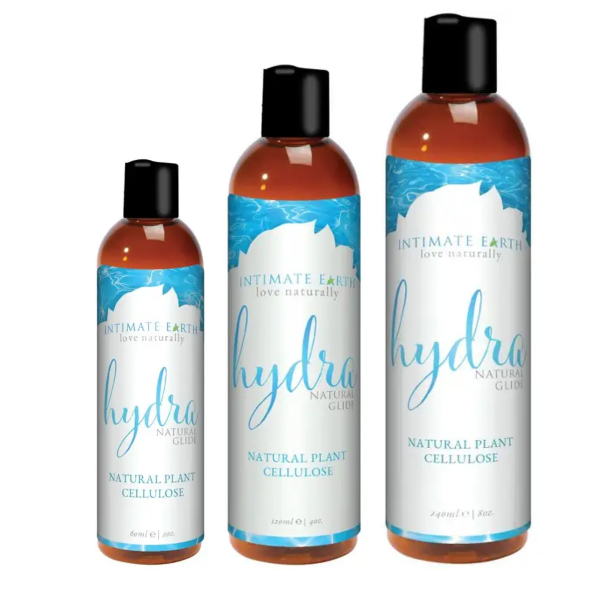 Size comparison view showing three amber bottles of Intimate Earth Hydra natural plant cellulose glide standing side by side in 60 ml (2 fl oz), 120 ml (4 fl oz), and 240 ml (8 fl oz) capacities.