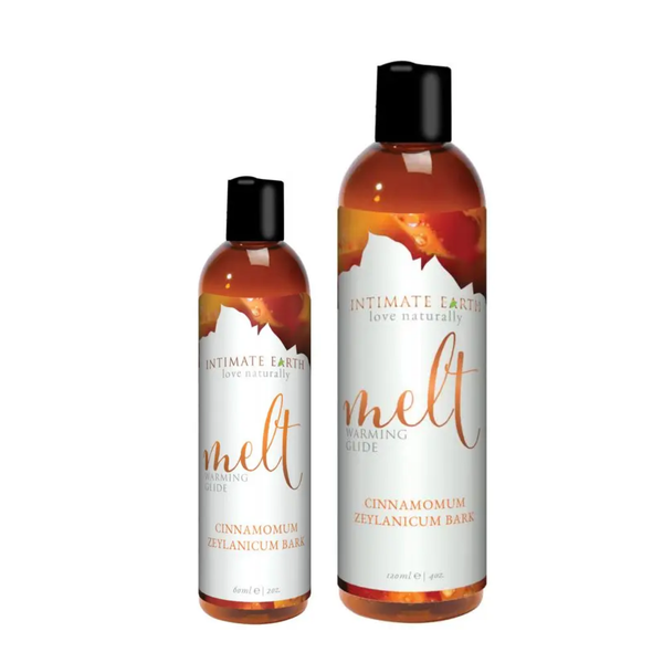 Size comparison view showing two amber bottles of Intimate Earth Melt warming glide standing side by side in 60 ml (2 fl oz) and 120 ml (4 fl oz) capSize comparison view showing two amber bottles of Intimate Earth Melt warming glide standing side by side in 60 ml (2 fl oz) and 120 ml (4 fl oz) capacities.acities.