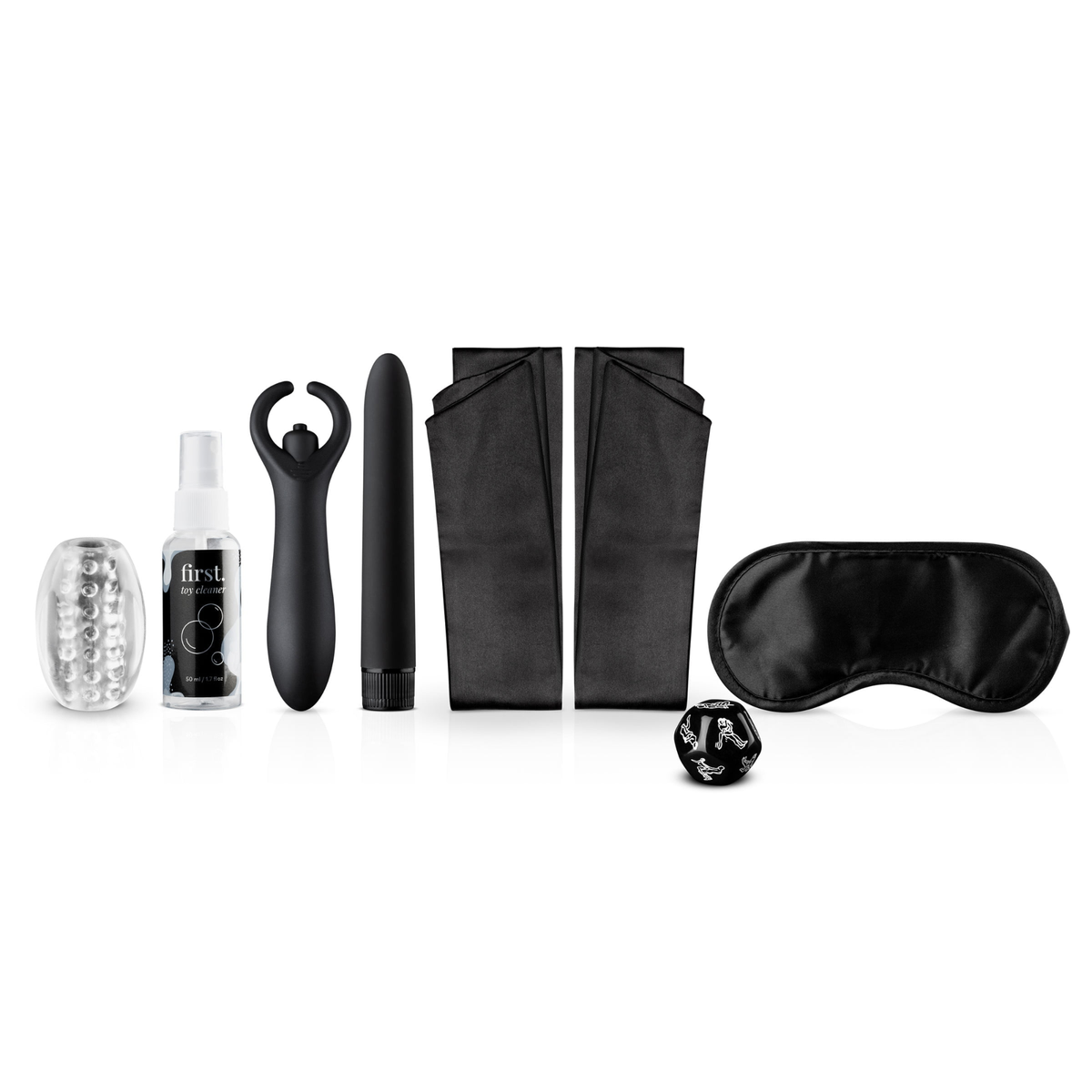 The contents of the LoveBoxxx First Together Starter Set arranged, including a clear masturbator sleeve, toy cleaner spray, two black vibrators (a couple's toy and a bullet), two black satin strips for handcuffs, a black satin blindfold, and a black sex dice.