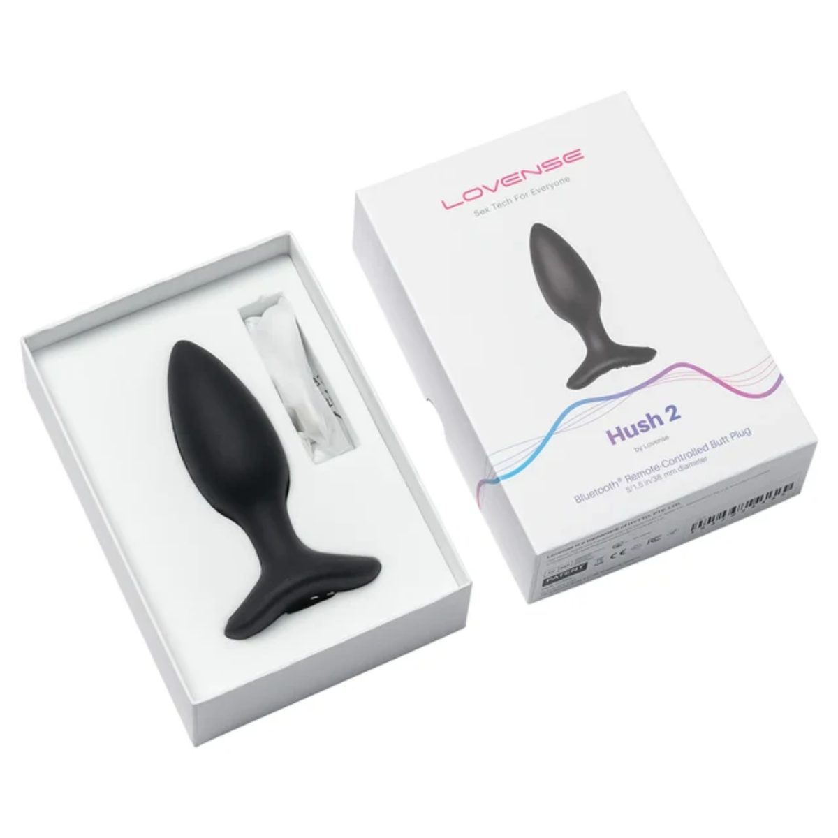 Unboxing perspective photo showing the black 1.5-inch Lovense Hush 2 butt plug resting in the open white box base alongside the charging cable and box lid.
