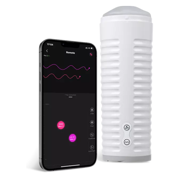 Studio product shot displaying the white Lovense Max 2 masturbator next to a smartphone showing its companion remote-control app interface.