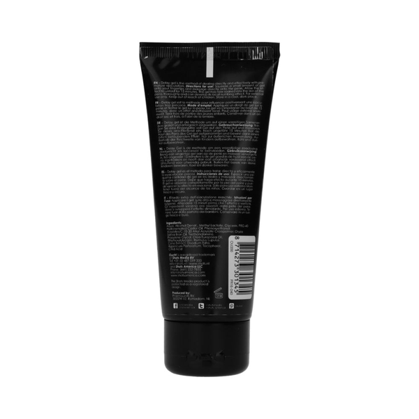 Back packaging view of the 100 ml (3.38 fl oz) Shots Delay Gel squeeze tube displaying multi-language instructions, full ingredients list, barcode, and manufacturer details.