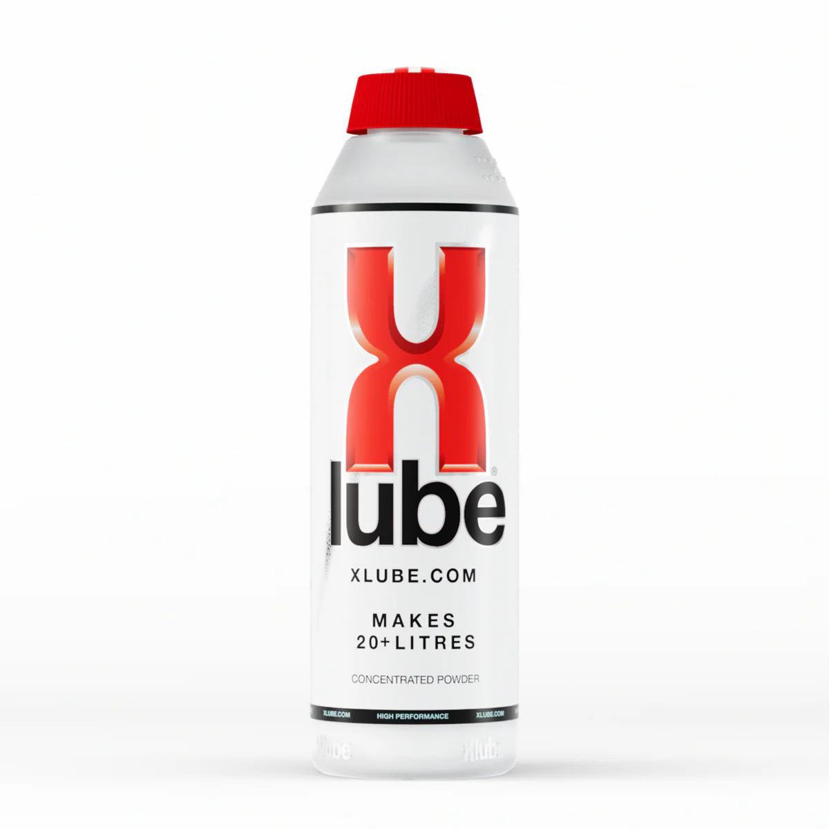A vertical shot of a clear plastic bottle of X Lube powder lubricant in the white background. The bottle has a red cap and is primarily white with red and black text. The large red "X" and black "lube" logo is prominent in the center. Smaller text below the logo reads "Xlube.com" and "MAKES 20+ LITRES / CONCENTRATED POWDER". Imagen principal del producto