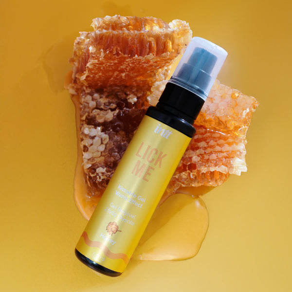 Bottle labeled 'Lick Me' with honeycomb on a yellow background