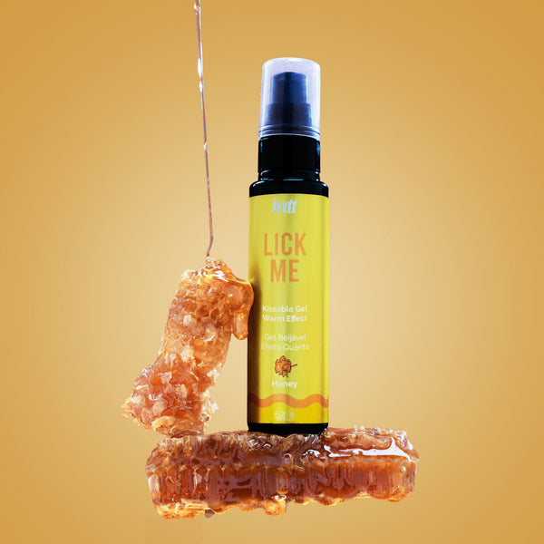 Bottle labeled 'Lick Me' with honey on a yellow background