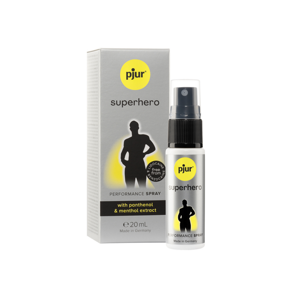 A gray and white box and a small white spray bottle of Pjur Superhero Performance Spray are positioned against a white background.